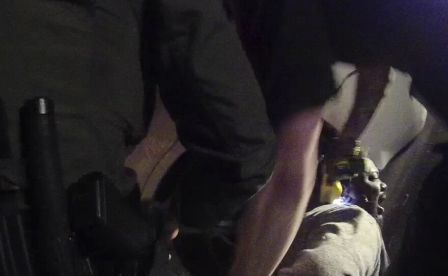 In this image made from a March 28, 2019, body camera video provided by the Austin, Texas, Police Dept., Williamson County Sheriff's deputies hold down Javier Ambler as one of them uses a stun gun on Ambler during his arrest. Ambler eventually died.