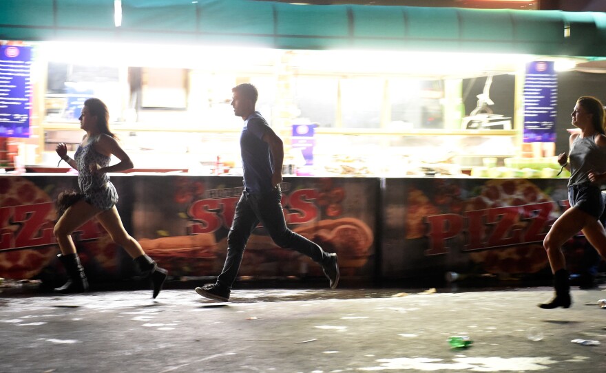 Concertgoers run from the Route 91 Harvest music festival in Las Vegas after the gunfire broke out. By the time the night was over, at least 58 people had died and more than 500 people were wounded in the shooting.