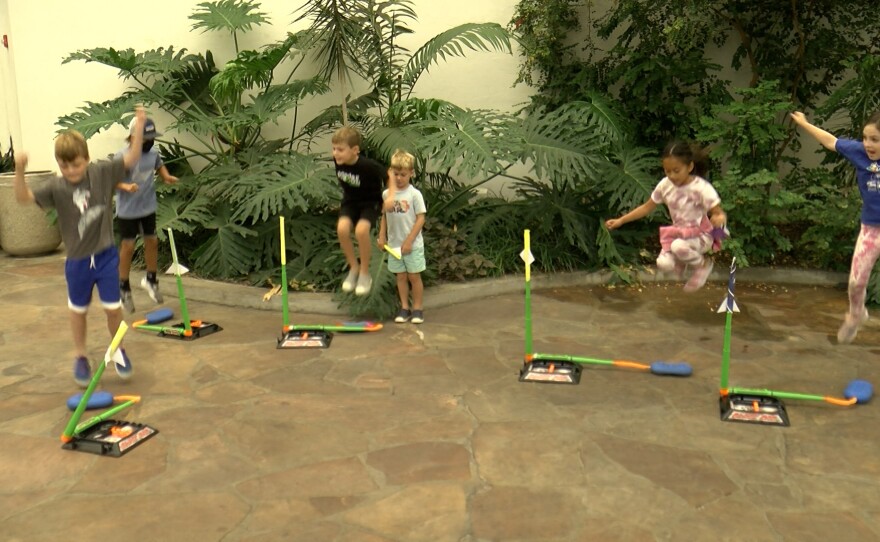 A group of children jump on stomp rockets at the San Diego Air & Space Museum in Balboa Park on July 14, 2022.