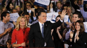 Republican presidential candidate, former Massachusetts Gov. Mitt Romney waves to supporters as his wife Ann looks on during his Florida primary night party on January 31, 2012 in Tampa, Florida. 