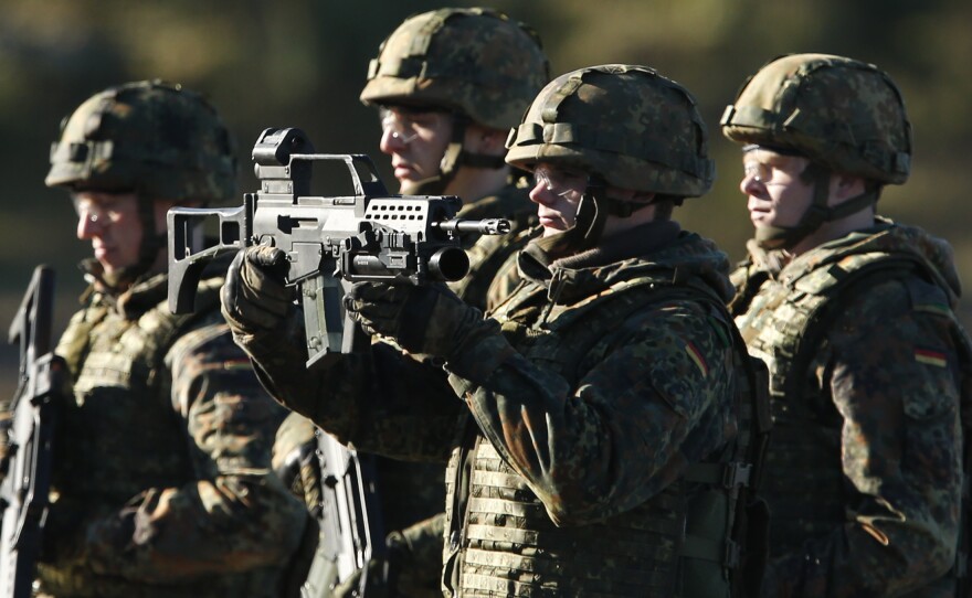 Soldiers of the Bundeswehr, the German army, present their Heckler & Koch G36 assault rifles during military exercises in 2013. Heckler & Koch is headquartered in Oberndorf, where many residents worry that their jobs will be at risk if Germany cuts back on arms shipments. Critics, meanwhile, point out that Heckler & Koch weapons are carried by the Taliban as well as by the Bundeswehr.