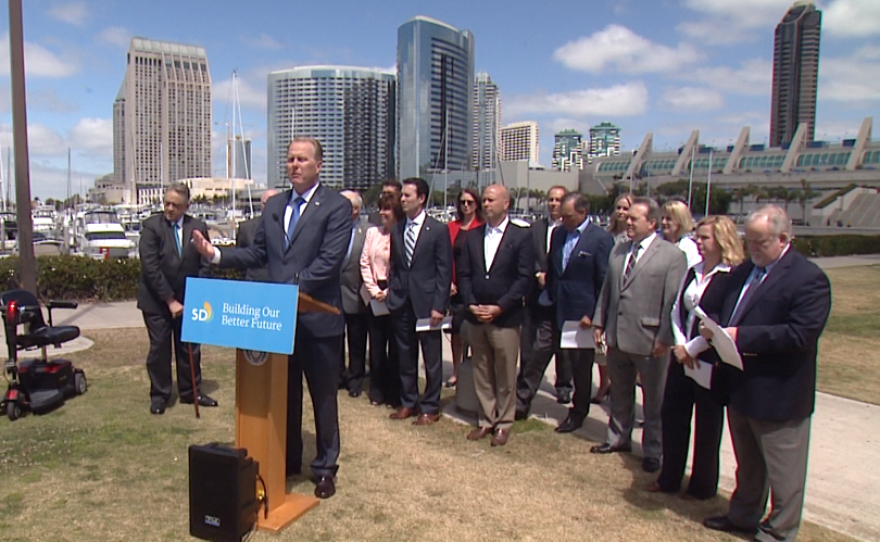 San Diego Mayor Kevin Faulconer announces a proposed ballot measure to raise the city's hotel room tax by up to 3 percent to fund a Convention Center expansion and pay for road repairs and homeless services, April 3, 2017, San Diego, Calif.