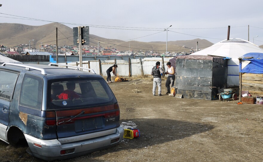 A scrapped automobile serves as a playground for the children of Gankhuyag, a former herder who lives in a ger or tent on the outskirts of Ulaanbaatar, the capital. The family moved here a few years ago when Gankhuyag started work as a porter.