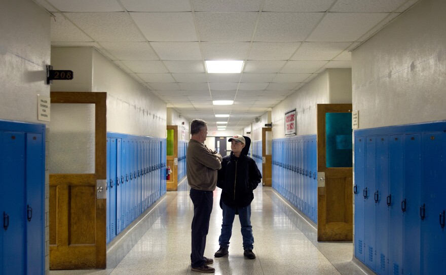 John Vowell (left) talks with Tyler Ryals, 12, of Saginaw, Mich. about school and friends after Ryals' guitar lesson. Major Chords for Minors moved into the old Fuerbringer Elementary School, which is now run by the REACH Community Church.