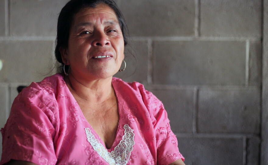 Maria Lopez Santos sits in her home that was built using remittances from family members who worked as undocumented migrants in the U.S.