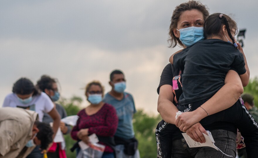 Migrants in La Joya, Texas, on Tuesday wait to be processed after crossing the Rio Grande into the United States.