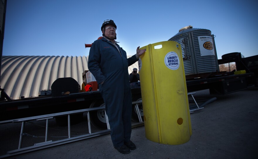 Dave Newcomb of the Illinois Fire Service Institute demonstrates the use of a grain rescue tube during an agricultural safety conference in Iowa in November.