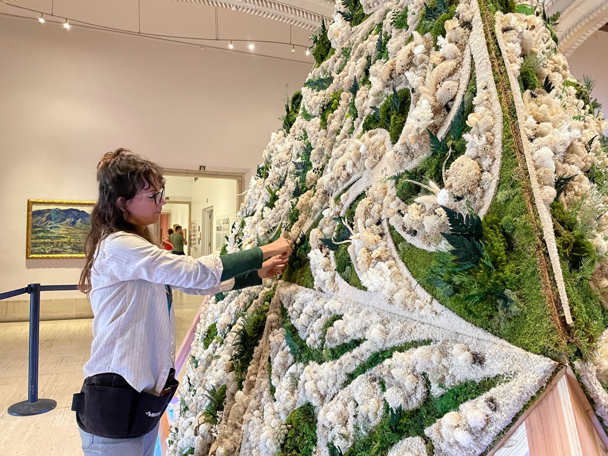 Artist Britton Neubacher adds preserved moss, ferns and other botanicals to her Art Alive rotunda installation, shown in-progress on Apr. 25, 2022. The final installation will be on view at San Diego Museum of Art Apr. 29-May 1, 2022.