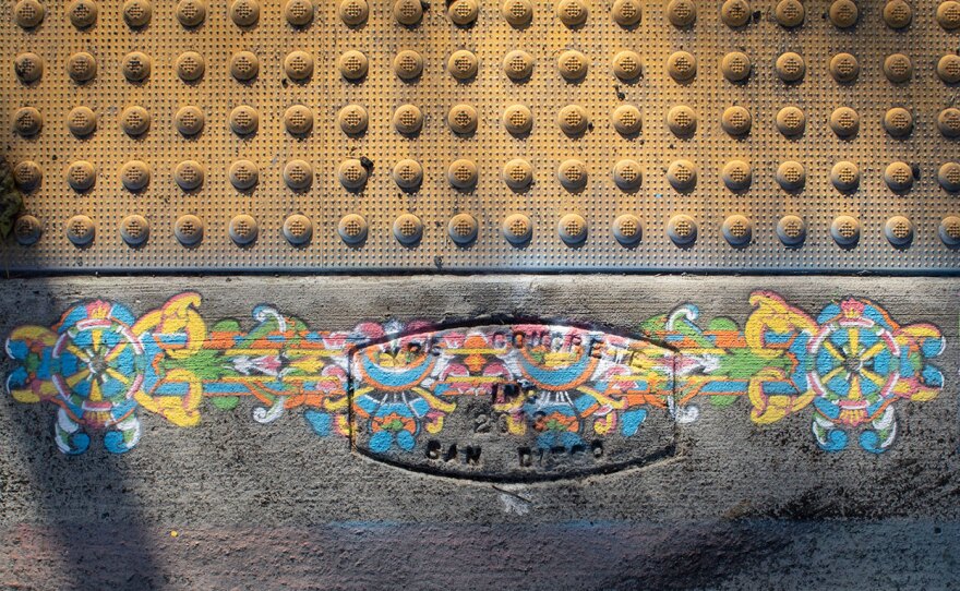 Detail of Margaret Noble's chalk spray paint designs for her Park Social public art installation, shown in an undated photo. The art spans the entire perimeter of Point Loma's Plumosa Park and includes a sound element.