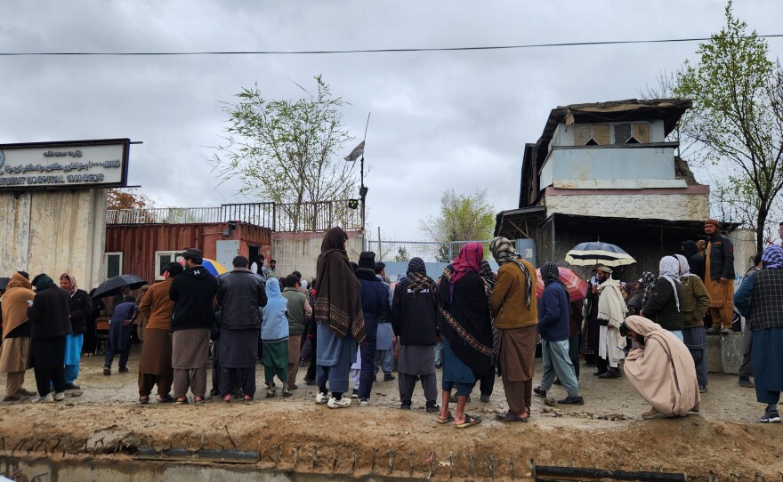 A crowd gathers outside Kabul's Omid Addiction Treatment Hospital, where the United Nations says an airstrike killed more than 100 people on March 16.