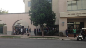 Students and staff stand outside of the SDSU Extended Studies Center during a power outage that impacted the west side of campus on Monday, Dec. 8, 2014.
