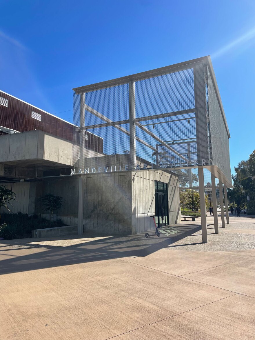 The exterior of the newly renovated Mandeville Art Gallery shows concrete, wood and steel architectural elements against a blue sky.