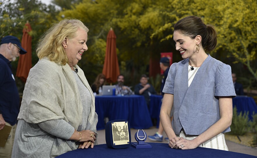 Katherine Van Dell (right) appraises a diamond horseshoe brooch, ca. 1900, at Desert Botanical Garden in Phoenix.