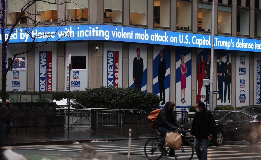News headlines on the impeachment trial of Donald Trump are displayed outside of the Fox headquarters in February in New York City.
