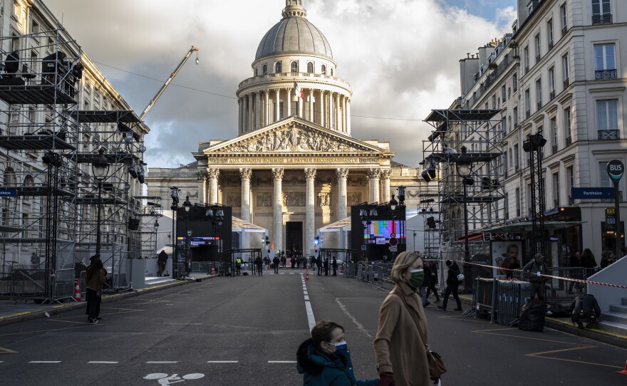 People cross a street close to the Pantheon in Paris. On Tuesday, Josephine Baker becomes the sixth woman to be commemorated in the Pantheon.