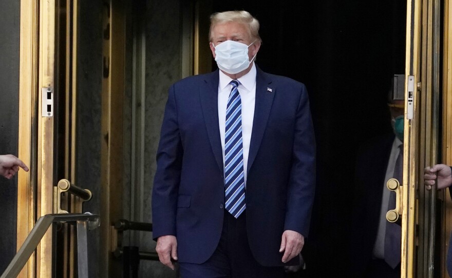 President Trump walks out of Walter Reed National Military Medical Center Monday.