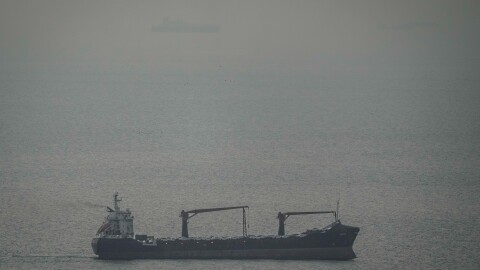 A cargo ship carrying vehicles sails through the Arabian Gulf toward the Strait of Hormuz in the United Arab Emirates, Sunday, March 22, 2026.