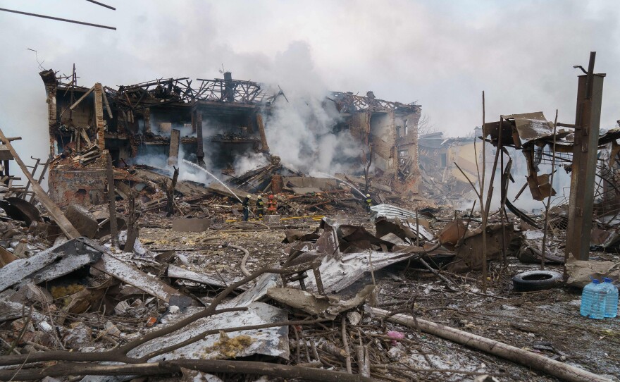 Firefighters spray water on a destroyed shoe factory following an airstrike in Dnipro, in central Ukraine, on March 11. Civilian targets came under Russian shelling that day in what appeared to be the first direct attack on the city. It has otherwise stayed largely safe from the war.