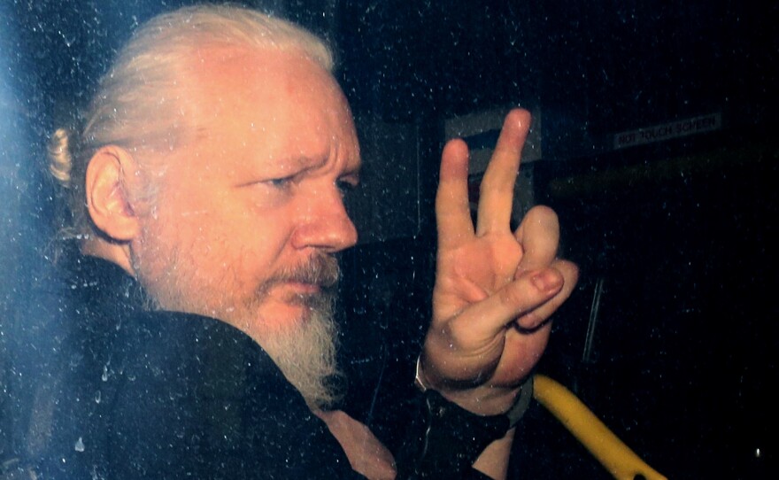 WikiLeaks founder Julian Assange arrives in a police vehicle at Westminster Magistrates court on Thursday in London. He was arrested by Scotland Yard police officers inside the Ecuadorian Embassy in Central London.