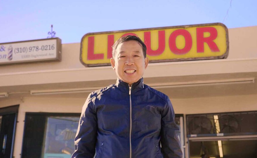 Hae Sup Um standing in front of his liquor store