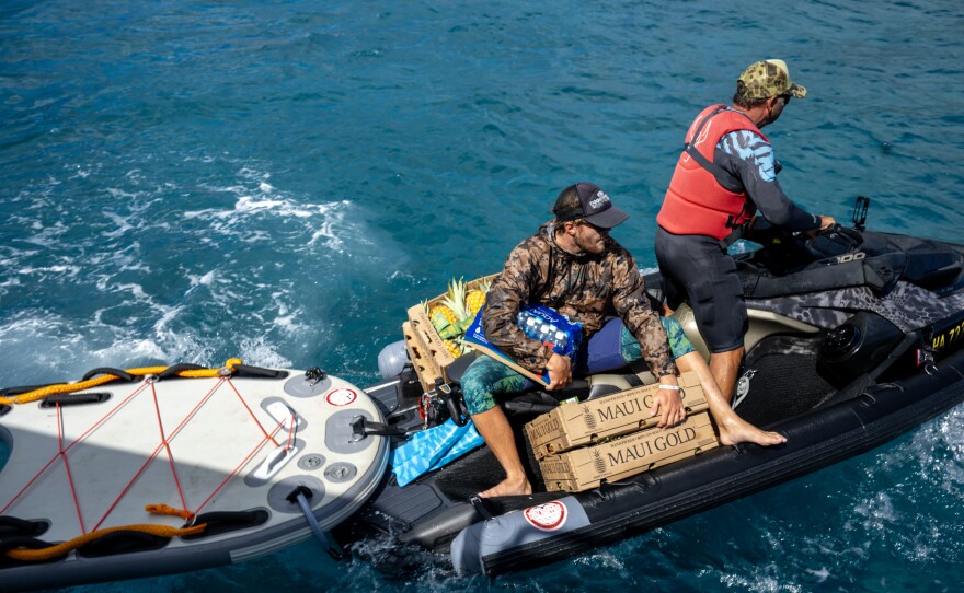 L to R: Cody Young and Scott Sanchez from the local surfing community are shuttling donated items on jet boats to get them from large boats to the shore on the north side of Lahaina.