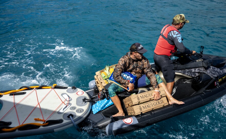 L to R: Cody Young and  Scott Sanchez from the local surfing community are shuttling donated items on jet boats to get them from large boats to the shore on the north side of Lahaina.