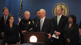 San Diego Mayor Jerry Sanders stands with city officials as he unveils new plans for a smaller, less expensive city hall project than one first proposed, June 24, 2010 at City Hall.