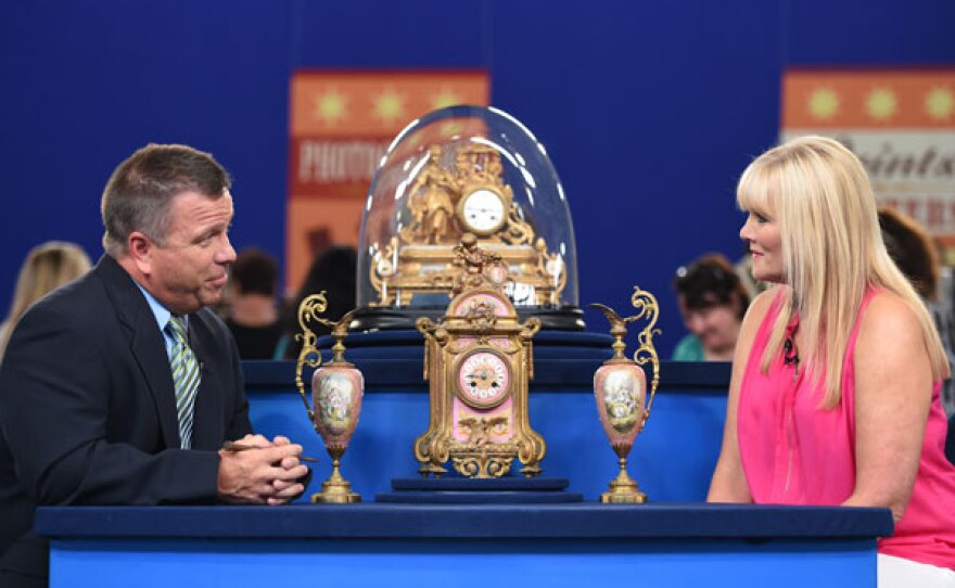 John A. Delaney (left) appraises 19th century French figural clocks in Charleston, West Virginia.