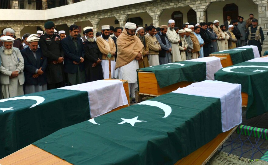 Security officials attend the funeral of police officials killed by bombs in Jamrud, Pakistan, March 1. The men were escorting a team of polio vaccinators when their vehicles were targeted.