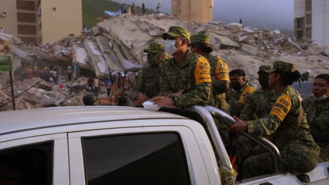 Venezuelan firefighters and volunteers search for possible victims atop a collapsed building in Caraballeda, La Guaira state, Venezuela, on Saturday, June 27, 2026.