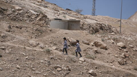 Palestinian students walk on their way home after receiving their year end reports from school, in the West Bank Bedouin hamlets of Khan al-Ahmar, Wednesday, June 10, 2026.