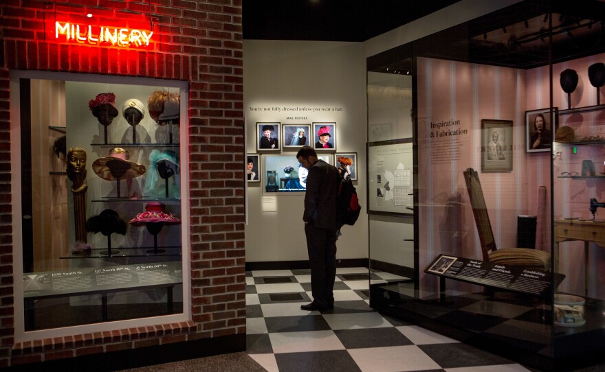 A visitor views a partial recreation of Mae's Millinery, a Philadelphia hat shop that once served Ella Fitzgerald and Lena Horne, at the National Museum of African American History and Culture.