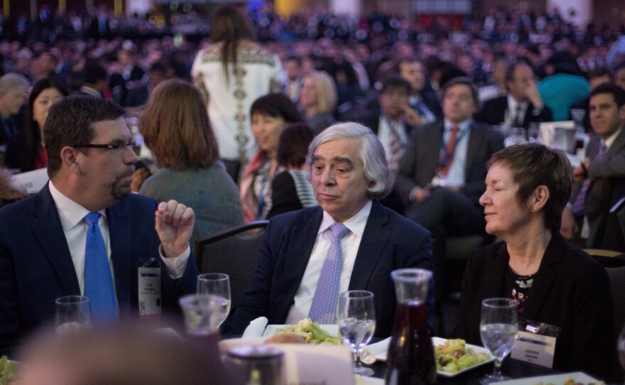 Energy Secretary Ernest Moniz, center, sits with other guests at the SelectUSA Investment Summit in Washington on Monday.