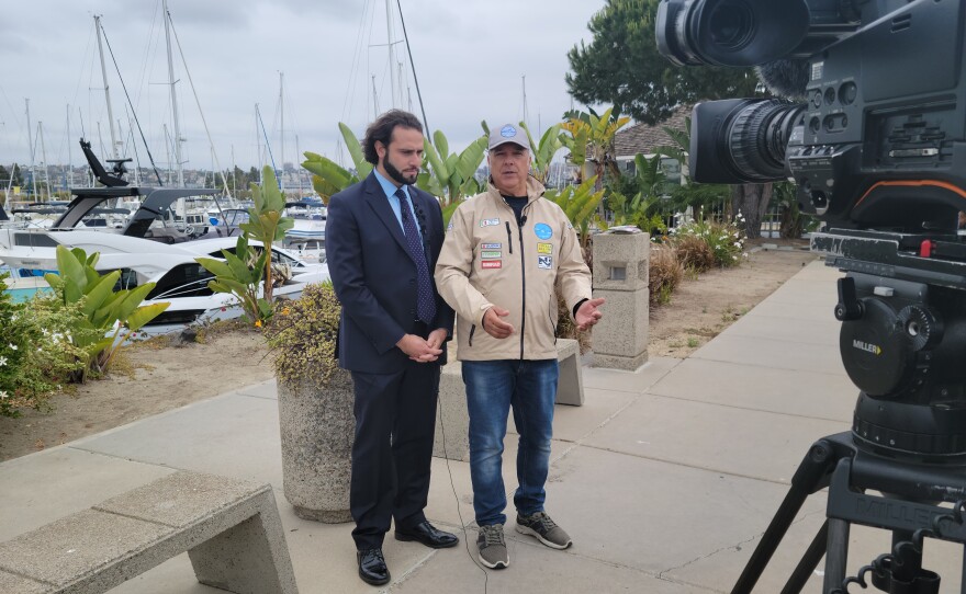 Captain Sergio Davi stands next to Pietro Bellinghieri who translated for him, at Harbor Island on May 20, 2022.