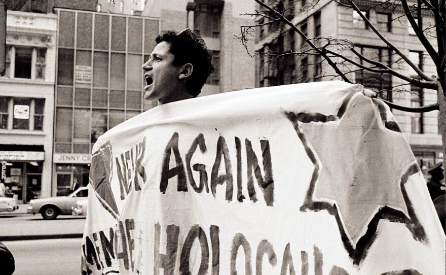 Chicago AIDS activist Danny Sotomayor holding a banner during a protest, April 1990. Credit: Lisa Howe-Ebright, photographer