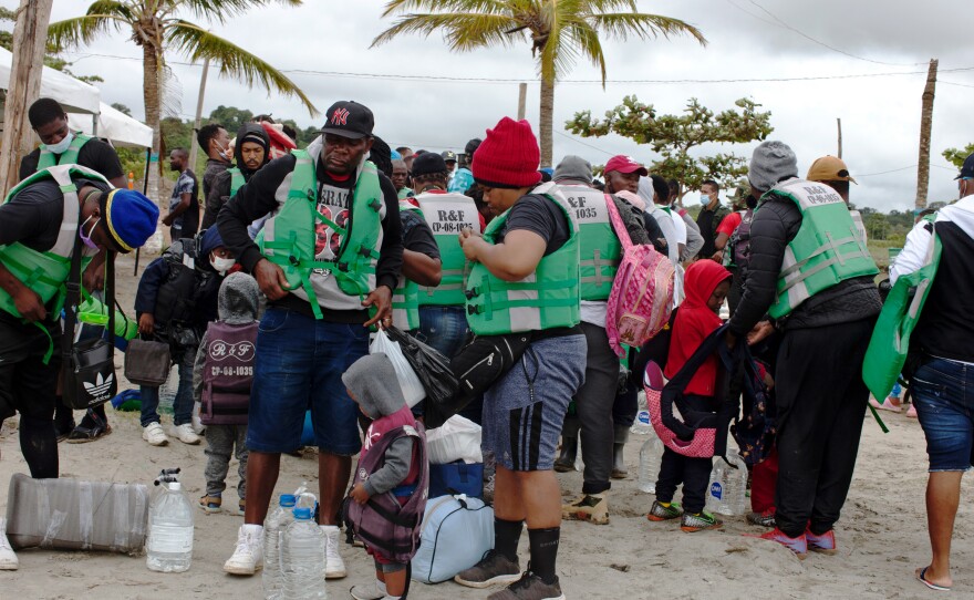 Haitian migrants try on their life jackets in Necoclí, ready to embark on their journey across the Gulf of Urabá.