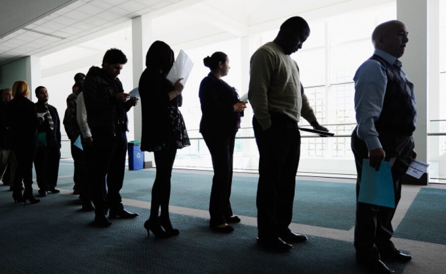 Job seekers line up to enter a career fair in Los Angeles. Both Congress and states are cutting back on unemployment benefits.