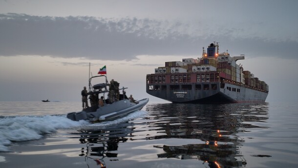 A Revolutionary Guard Navy (IRGC) speedboat approaches the cargo ship Epaminondas during what state media described as the seizure of one of two vessels accused of violations in the Strait of Hormuz, April 21, 2026.