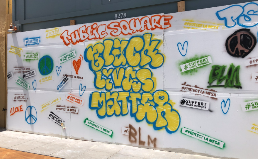 A "public square" banner hangs on a wall in La Mesa where people can paint and post stickers related to demonstrations over police brutality, May 31, 2020.