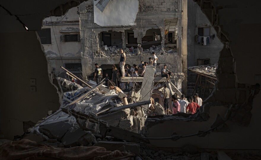 Palestinians look at the destruction after Israeli strikes on the Gaza Strip in Khan Younis, Nov. 4, 2023.