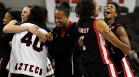 The Lady Aztecs celebrate their upset win. 