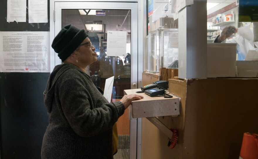 Pauletta Jackson drops off her prescription for Suboxone at the pharmacy just downstairs from Chapman's clinic.