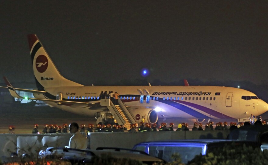 Bangladesh's state-run Biman Bangladesh Airlines flight is seen after it made an emergency landing at the airport in Chittagong, Bangladesh on Sunday.