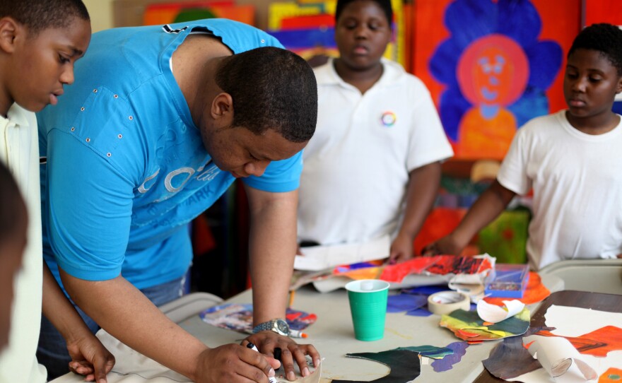 Maurice Kie, a mentor with the program, helps participants brainstorm their life goals. Kie has been with Life Pieces to Masterpieces since he was 9. He was one of the seven first apprentices.