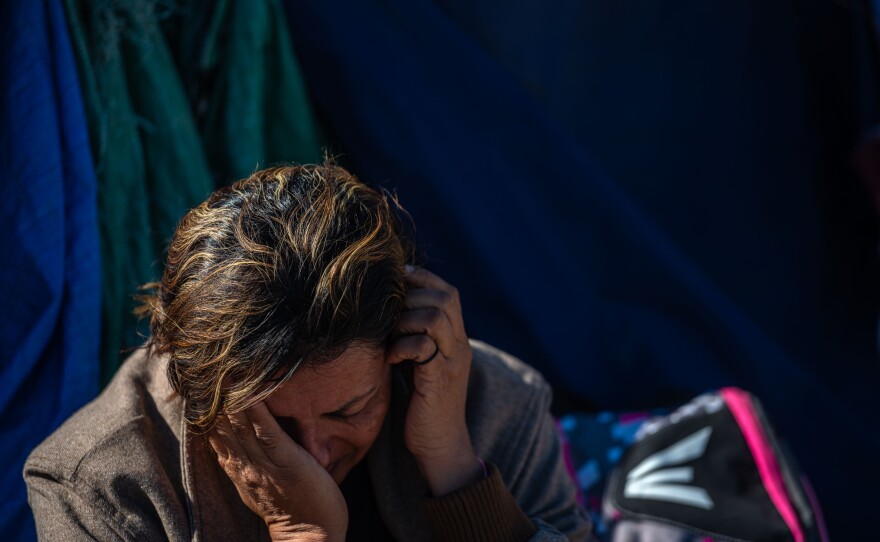 A migrant who came from Honduras after receiving threats because of her sexuality rests in Jacumba, Calif., after a long walk to the U.S.
