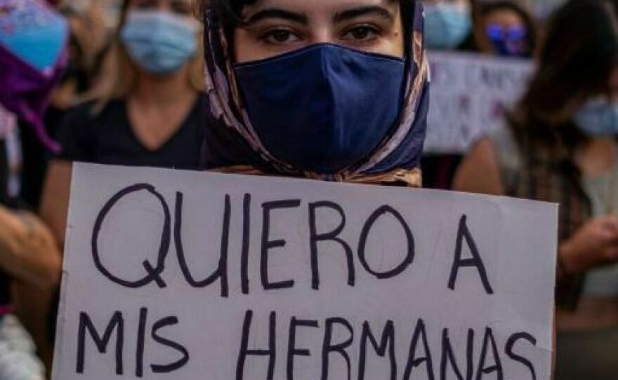 A member of a feminist collective holds a sign that reads in "I Want My Sisters Alive" in Spanish during a demonstration against sexual violence in front of the governor's mansion in San Juan, Puerto Rico in 2021.