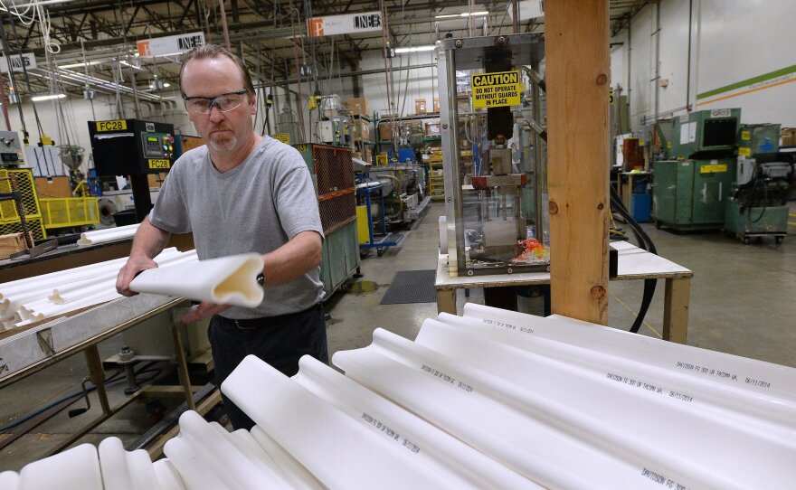 A worker stacks traffic safety poles at Pexco's manufacturing center in Fife, Wash. The small company ships products all over the world, with the help of federal insurance from the Export-Import Bank.