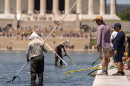 Visitors watch as National Park Service employees use vacuums to clean the Lincoln Memorial Reflecting Pool, Saturday, June 20, 2026, in Washington.
