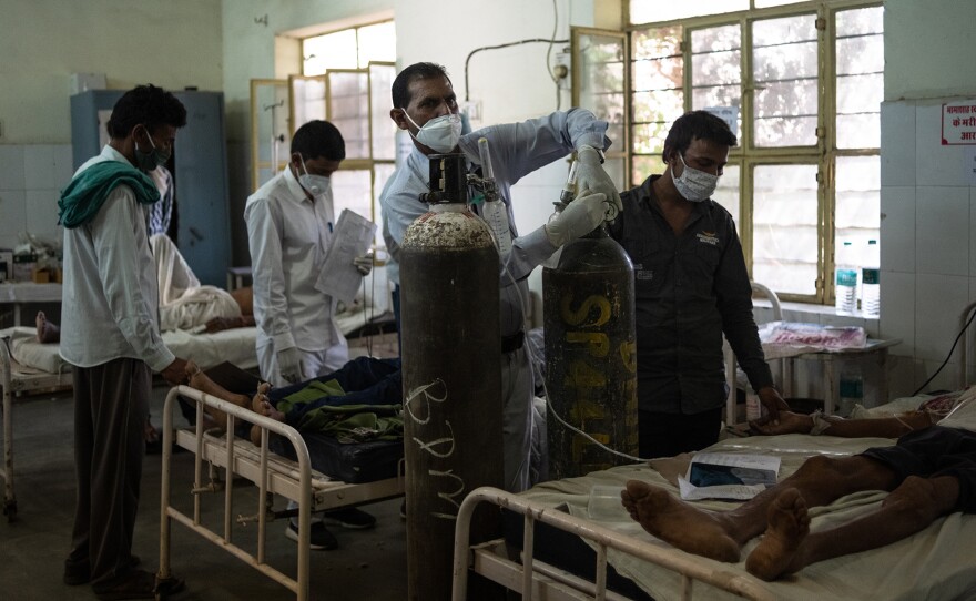 Indian medical attendant Gurmesh Kumawat prepares to administer supplemental oxygen to a coronavirus patient in the emergency ward at the BDM Government Hospital on May 15 in Kotputli, Jaipur District, Rajasthan, India.