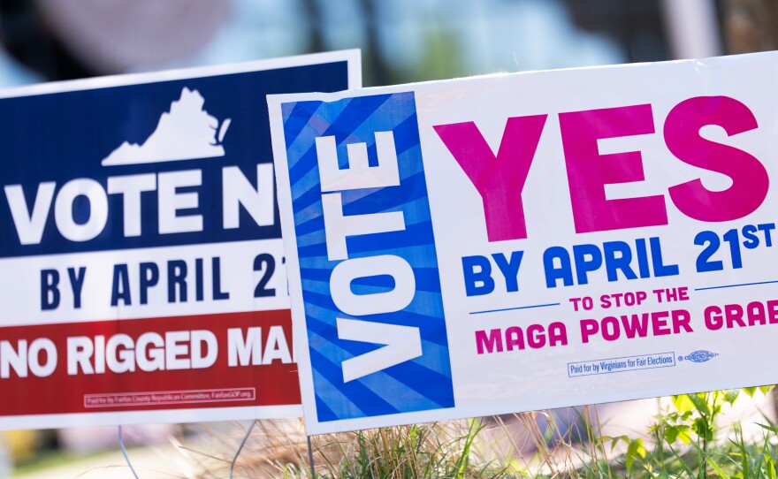 Signs are seen during the Virginia redistricting referendum on April 21 in Fairfax, Va.